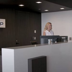RESICAP Front desk receptionist greeting someone