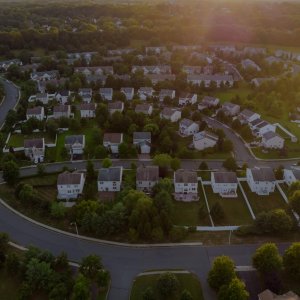 Dawn in the sleeping area of a small town with a forest on the background. View from a height