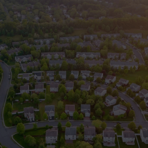 Dawn in the sleeping area of a small town with a forest on the background. View from a height